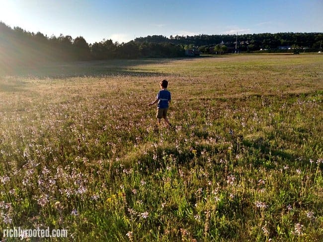 Boy running through a field